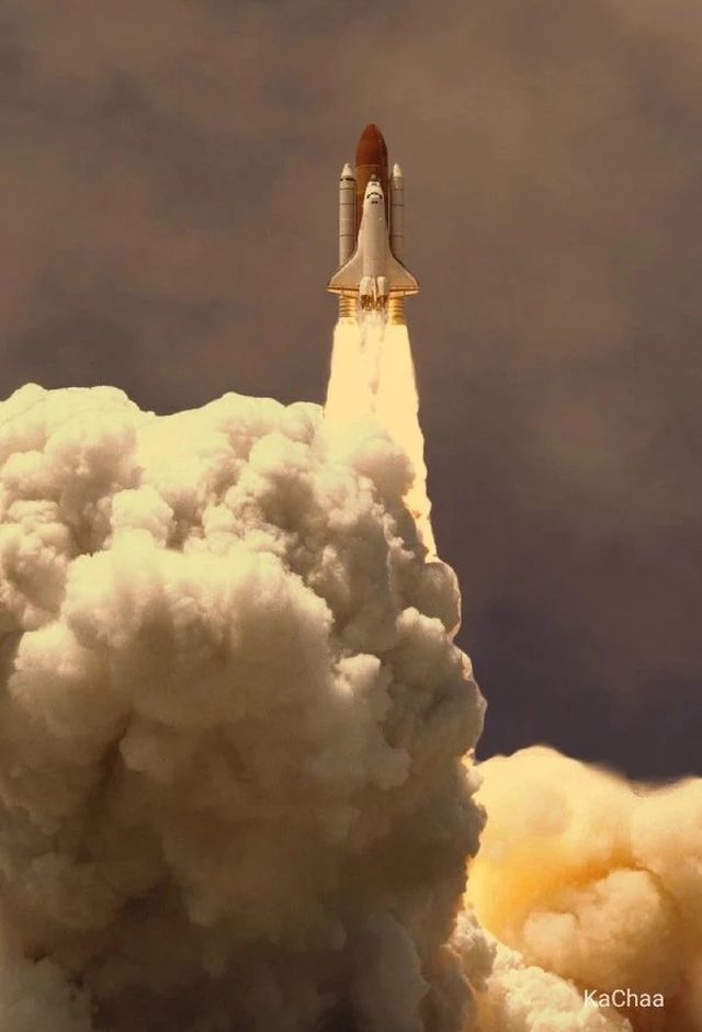 A space shuttle rising out of a cloud of smoke into a dark sky.